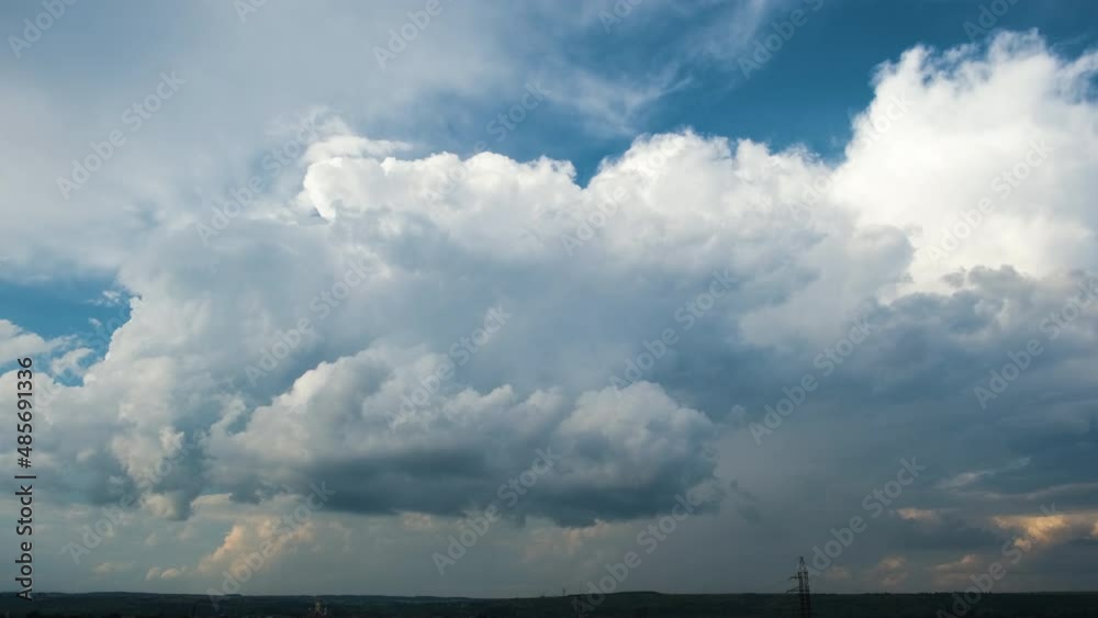 Timelapse of white puffy cumulus clouds forming on summer blue sky. Moving and changing cloudscape weather Timelapse of white puffy cumulus clouds forming on summer blue sky. Moving and changing cloudscape weather