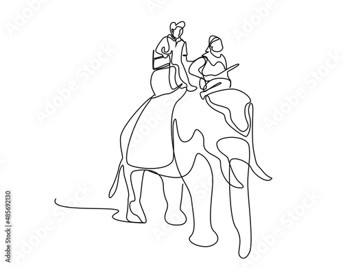 tourist and worker traveling on an elephant