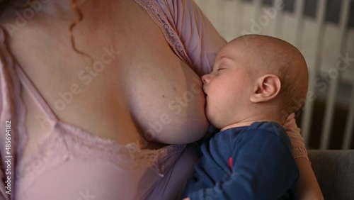 Close shot of a mother breastfeeding her baby boy
