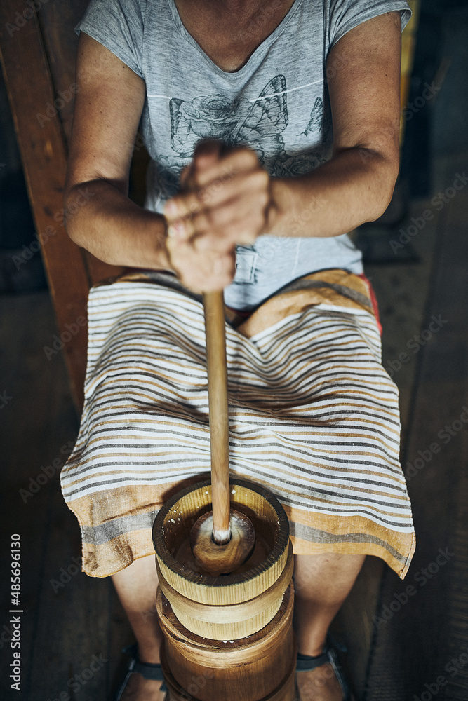 Woman making butter with butter churn. Old traditional method making of