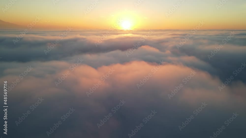 Aerial shot of the sunrise above a layer of clouds Aerial shot of the sunrise above a layer of clouds