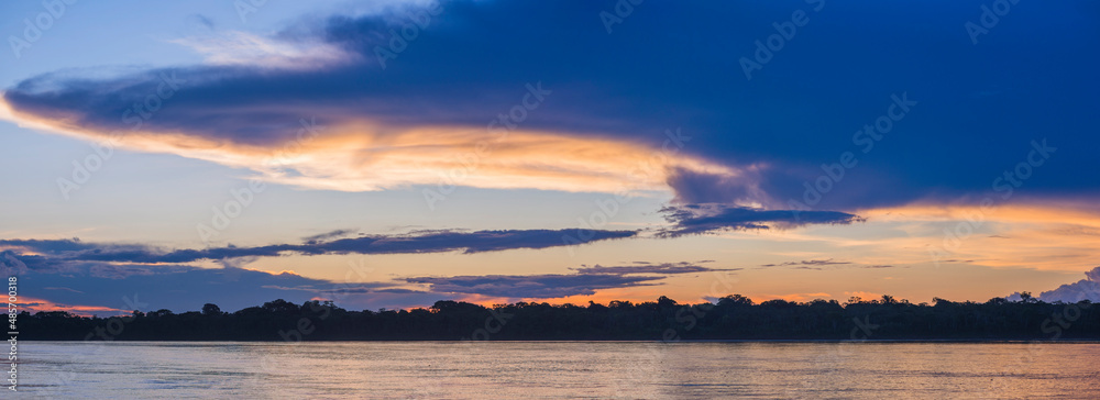 Fototapeta premium Sunset over river in Amazon Jungle of Peru, Tambopata National Reserve, Peru, South America