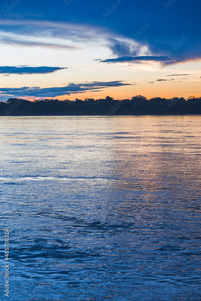 Fototapeta premium Sunset over river in Amazon Jungle of Peru, Tambopata National Reserve, Peru, South America