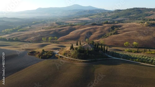 Val d'Orcia Tuscan rolling hills, famous farmhouse in countryside aerial view near San Quirico d'Orcia, Tuscany Italy.