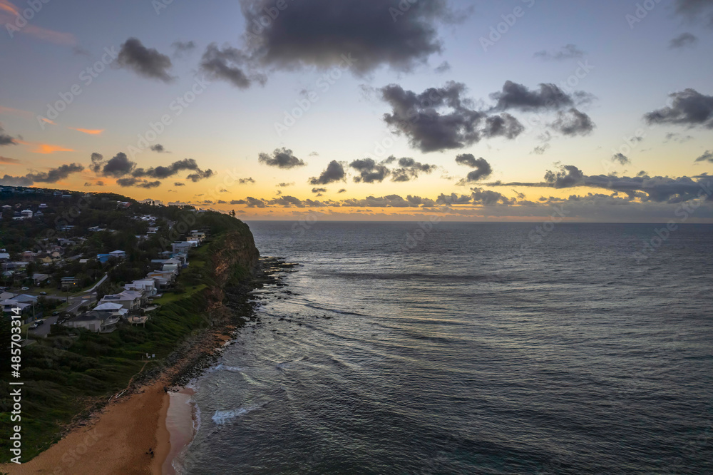 Obraz premium Breezy aerial sunrise seascape with clouds