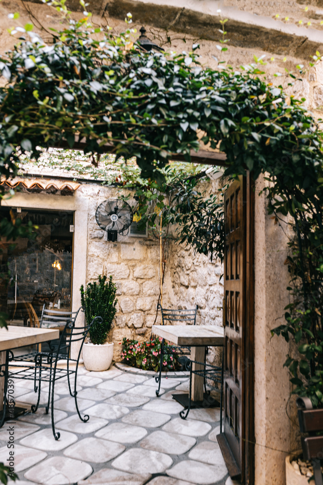 Fototapeta premium Inside view of Kotor hotel terrace in Montenegro in sunny day. Unesco world heritage. Europe travel site. Vacation concept. Peace and calm atmosphere for rest and inspiration, leisure time