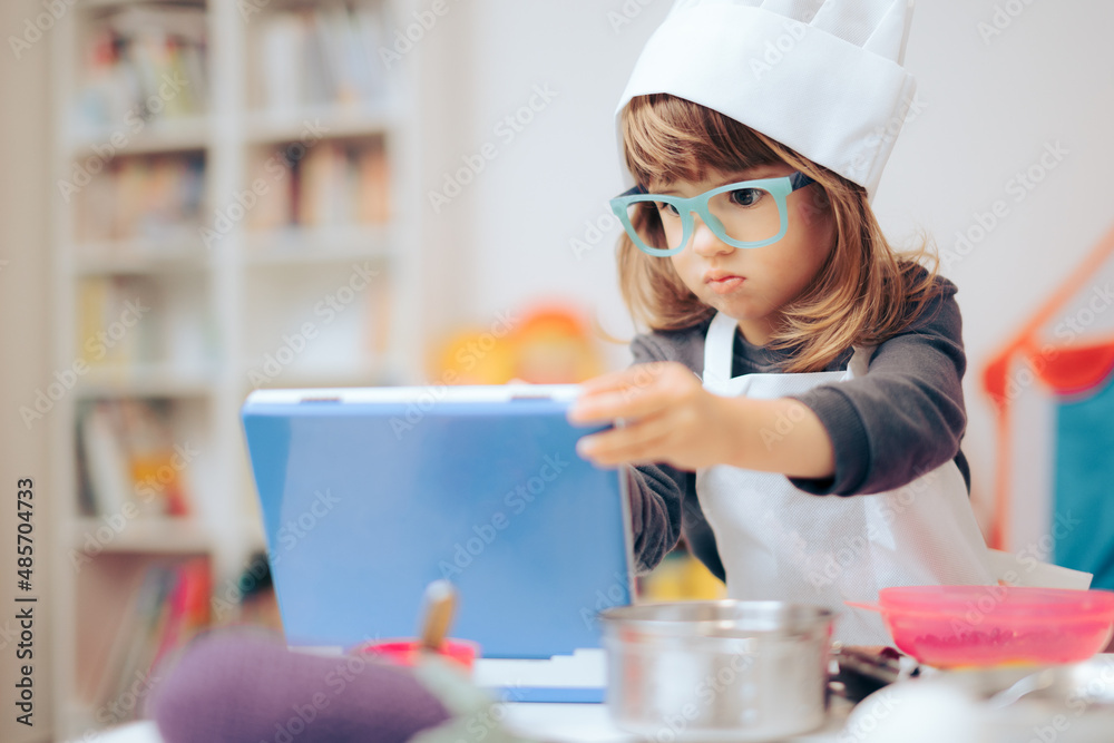 Little Chef Opening Toy Laptop Pretending to Look for a Recipe Little Chef Opening Toy Laptop Pretending to Look for a Recipe