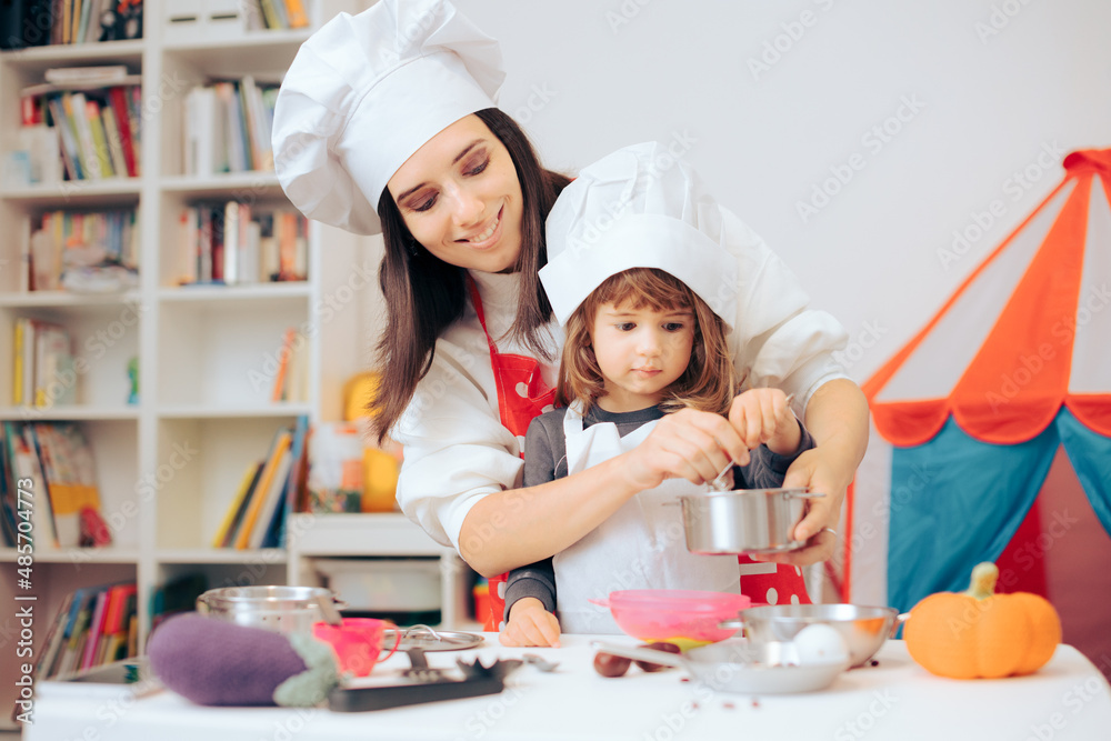 Mother and Daughter Playing together in Toy Kitchen Mother and Daughter Playing together in Toy Kitchen