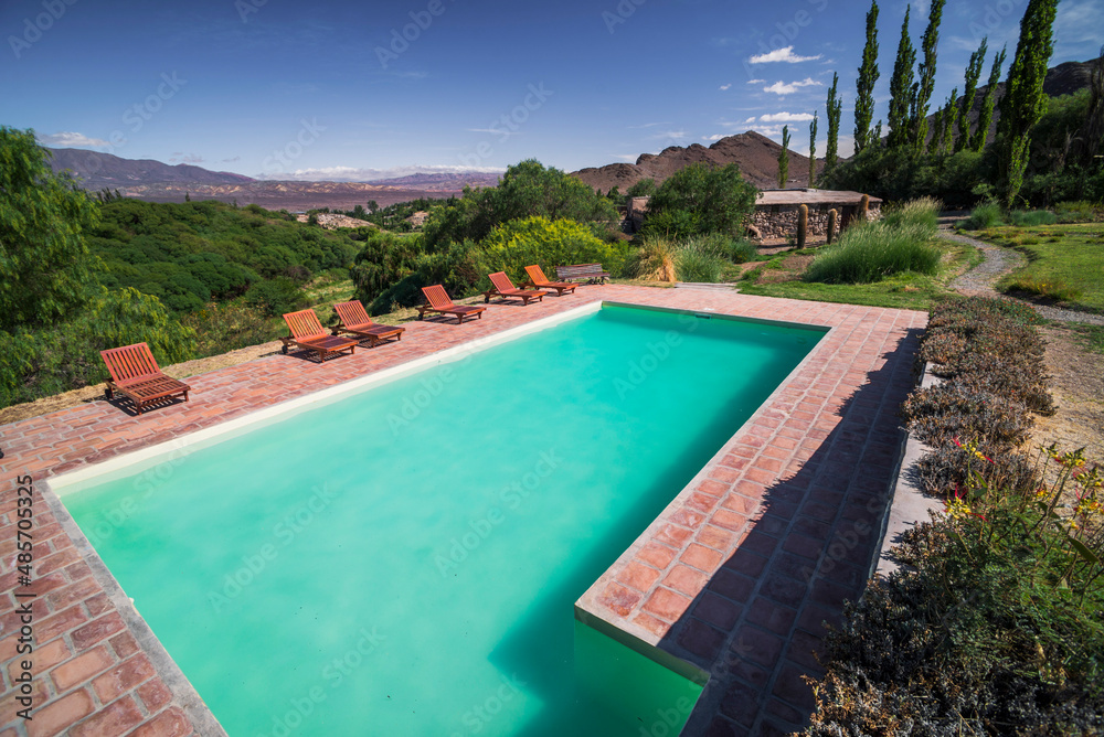 Outdoor swimming pool with amazing view of Andes Mountains and landscape, Cachi, Cachi Valley, Salta Province, North Argentina, South America