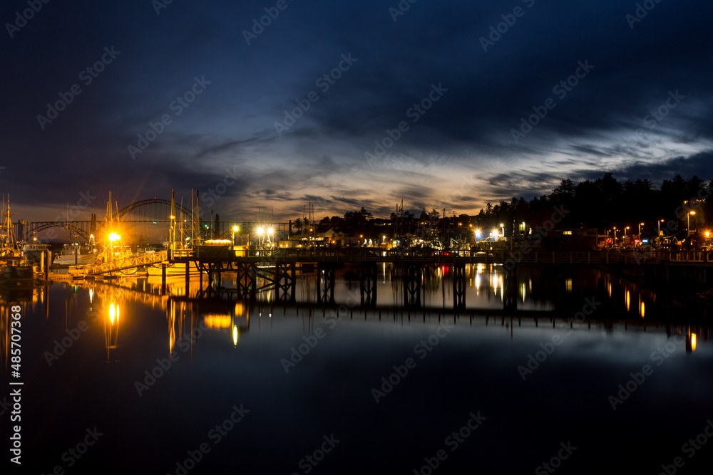 Newport marina and Yaquina Bay at night. Reflection in the calm water