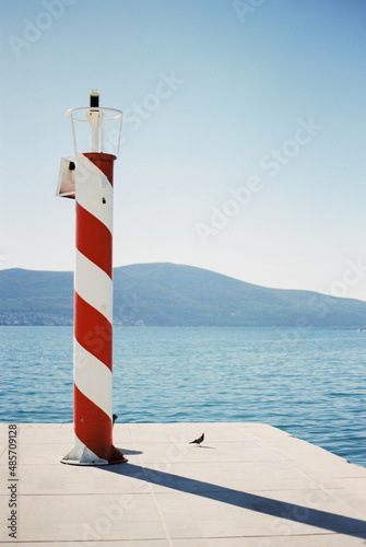 Solar powered automatic lighthouse at the pier in Porto. Montenegro © Nadtochiy