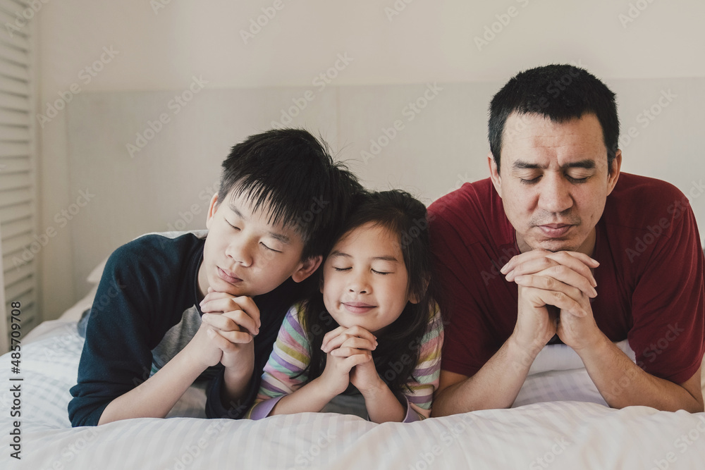 Children praying with father, family and kids fellowship worshiping online together at home, digital streaming church service concept Children praying with father, family and kids fellowship worshiping online together at home, digital streaming church service concept