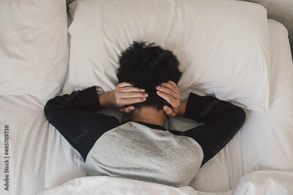 preteen-tween-boy-covering-ears-in-bed-adhd-sleep-disorder-mental