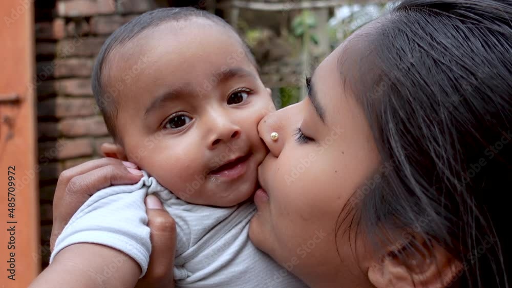 Mom is playing with his cute chubby baby boy in the afternoon time at the rooftop. Mother-baby care and motor development concept. Mom is playing with his cute chubby baby boy in the afternoon time at the rooftop. Mother-baby care and motor development concept.