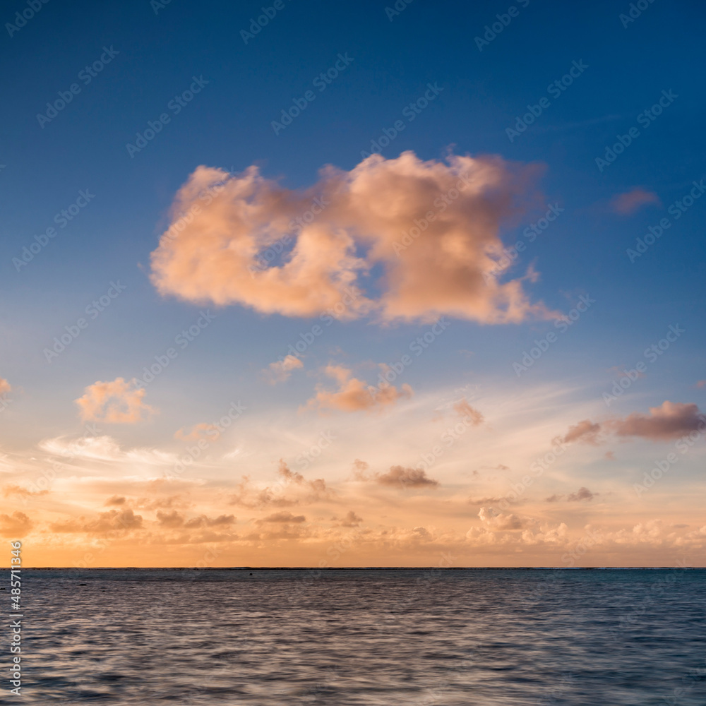Dramatic clouds at sunset over the horizon of the Pacific Ocean, Cook Islands, background with copy space