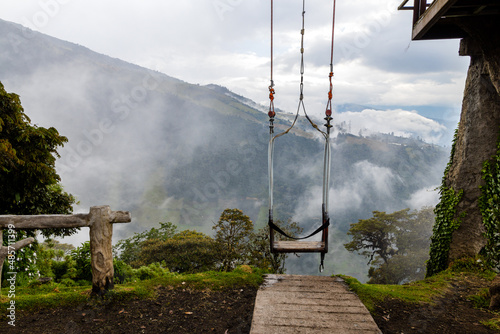 The Swing at the so called End of the World at Casa Del Arbol (Tree House) In Banos De Agua Santa, Ecuador, South America photo