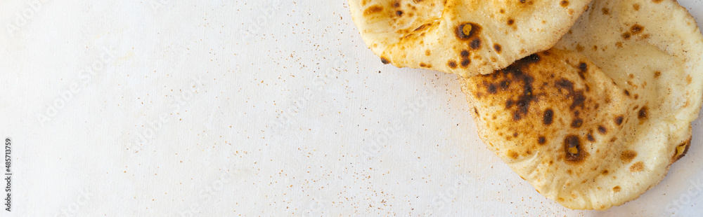 Egyptian Arab flatbreads - Aish Baladi top view on a beige background with copy space Egyptian Arab flatbreads - Aish Baladi top view on a beige background with copy space
