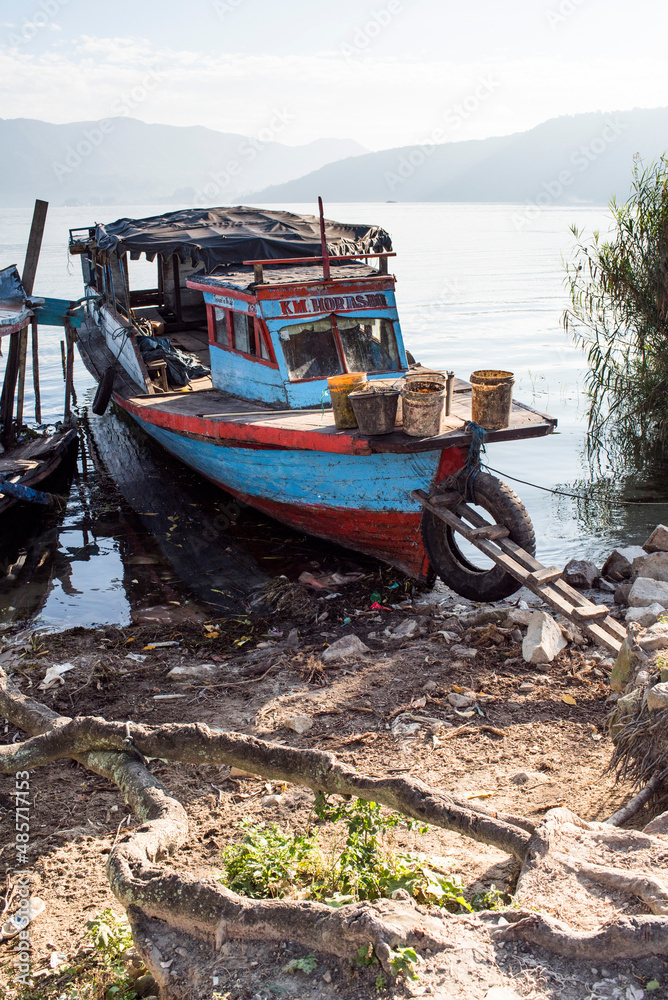 Old rusty fishing boat in a village at Lake Toba (Danau Toba), North Sumatra, Indonesia, Asia