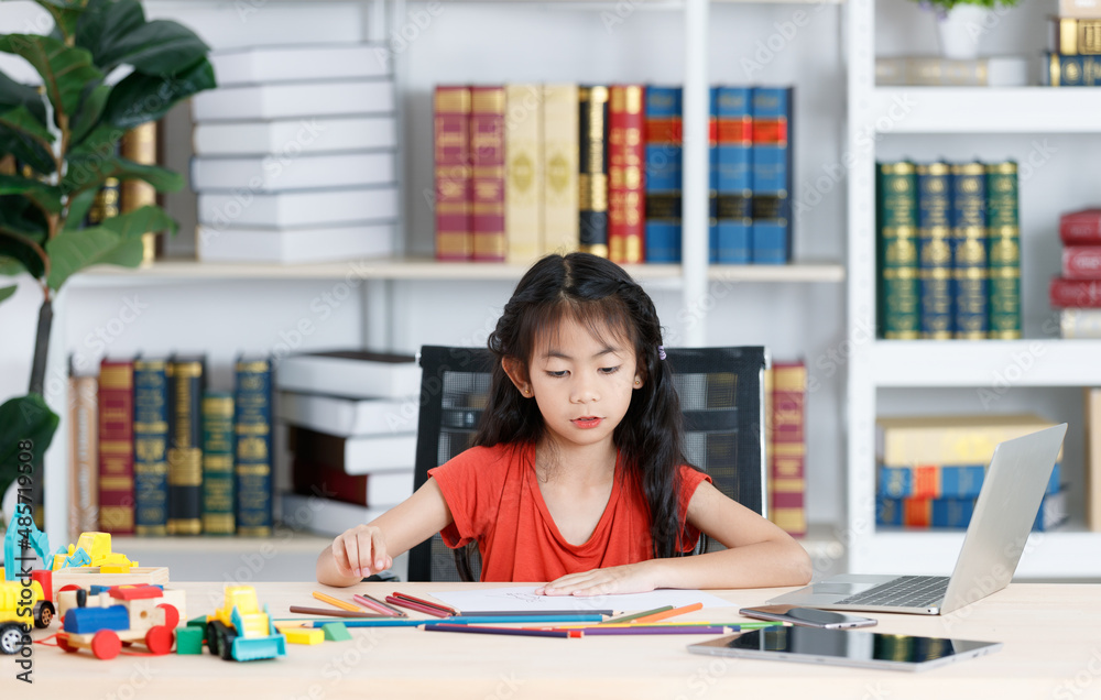 Asian creative young primary school girl artist in casual outfit sitting using color pencil drawing painting picture at home school classroom lesson in living room during pandemic quarantine period Asian creative young primary school girl artist in casual outfit sitting using color pencil drawing painting picture at home school classroom lesson in living room during pandemic quarantine period