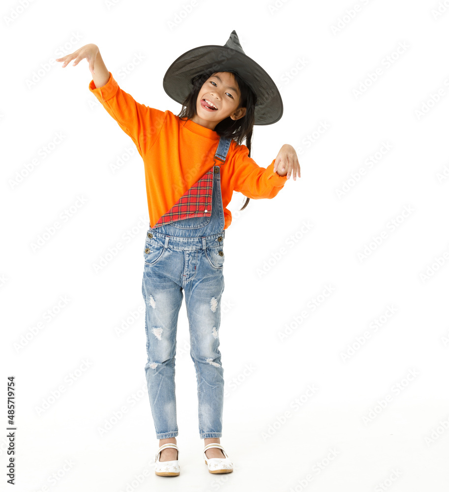 Portrait cutout isolated closeup studio shot Asian young girl in casual orange party costume with black witch hat holding tongue out standing posing spooky gesture look at camera on white background Portrait cutout isolated closeup studio shot Asian young girl in casual orange party costume with black witch hat holding tongue out standing posing spooky gesture look at camera on white background