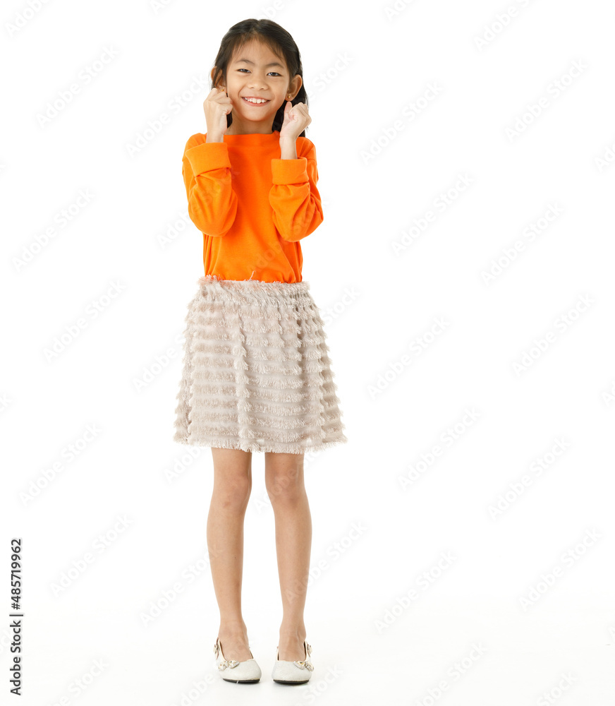 Full body cutout isolated studio shot of Asian young primary schoolgirl model in casual orange shirt and skirt outfit standing on white background Full body cutout isolated studio shot of Asian young primary schoolgirl model in casual orange shirt and skirt outfit standing on white background