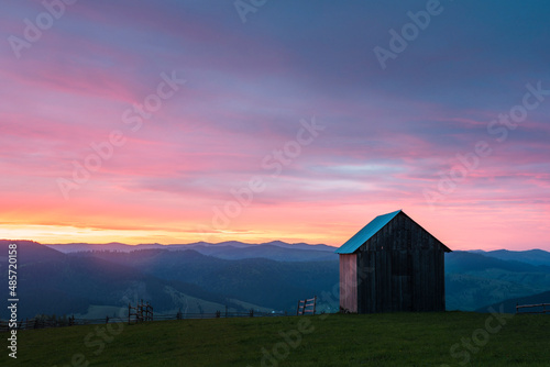 Rural Romanian landscape at sunrise in the Bukovina Region (Bucovina), Paltinu, Romania, background with copy space