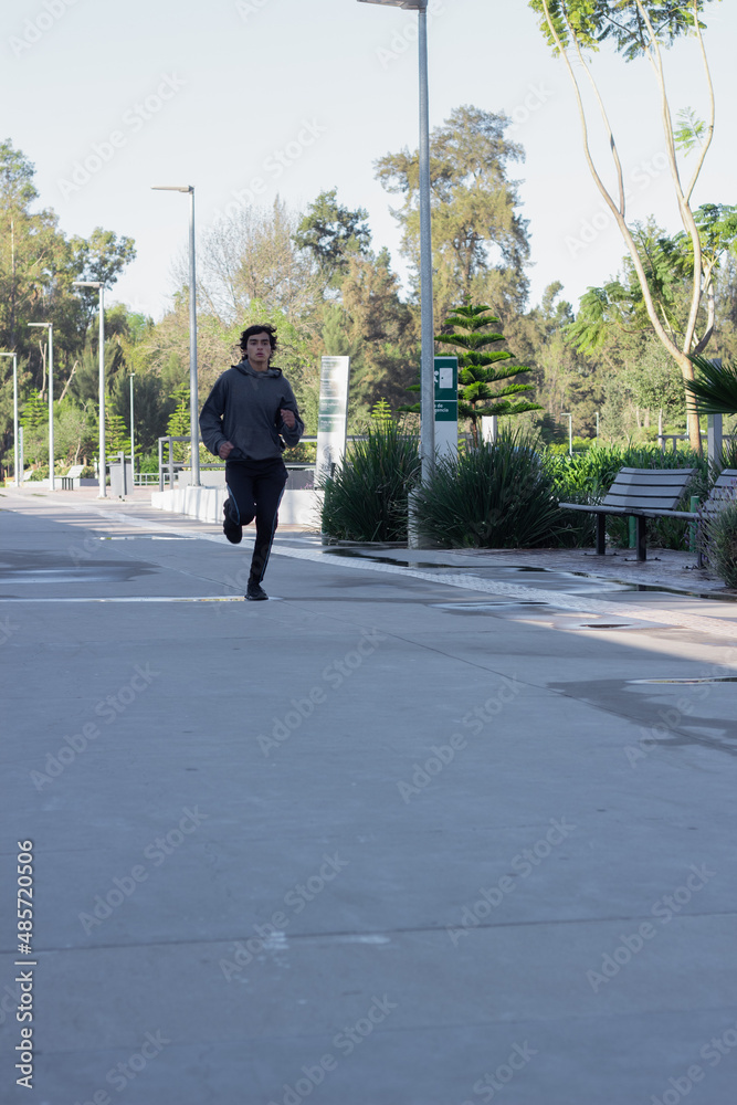 young athlete jogging in the outdoor park in the morning among nature young athlete jogging in the outdoor park in the morning among nature