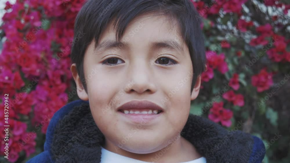 Happy little Mexican with a background full of flowers. Happy little Mexican with a background full of flowers.