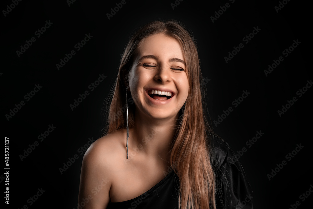 Portrait of happy young woman with jewelry on black background Portrait of happy young woman with jewelry on black background