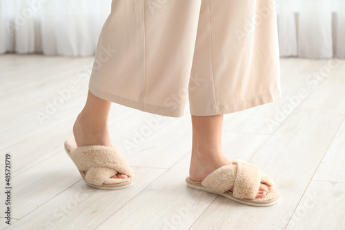 Young woman in soft comfortable slippers at home © Pixel-Shot