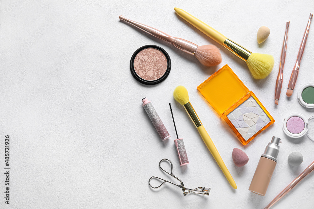 Different makeup products on light background Different makeup products on light background