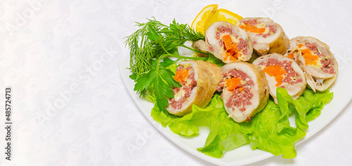 Sliced pieces of meatloaf lie on green lettuce leaves. Delicious and healthy food.