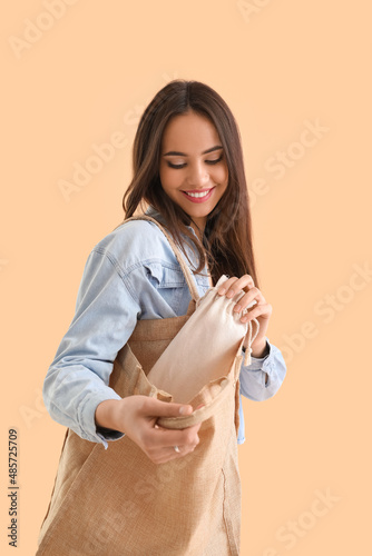 Young woman with eco bags o...