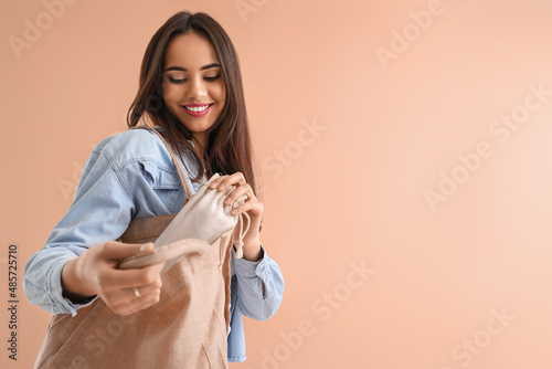 Young woman with eco bags o...