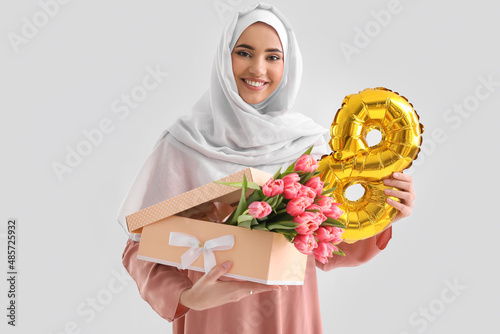 Muslim woman with gift box,...