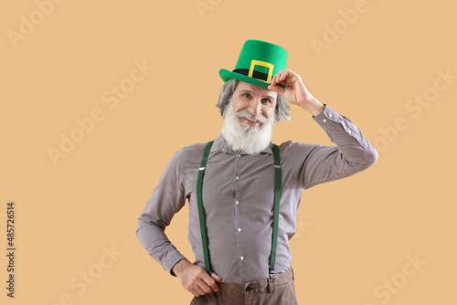 Senior man in green hat on ...