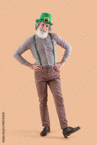Senior man in green hat on ...