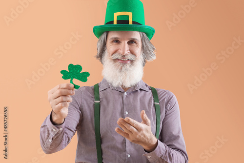 Senior man in green hat wit...