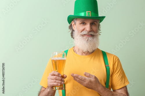 Senior man in green hat wit...