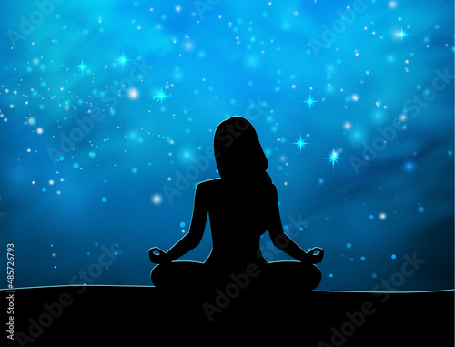 Woman meditating on the background of the starry sky
