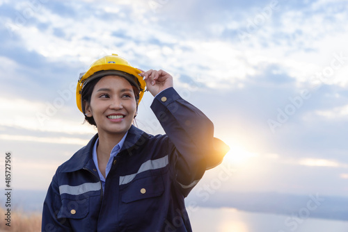 Young female engineer smiling and holding harthat looking to the future. photo