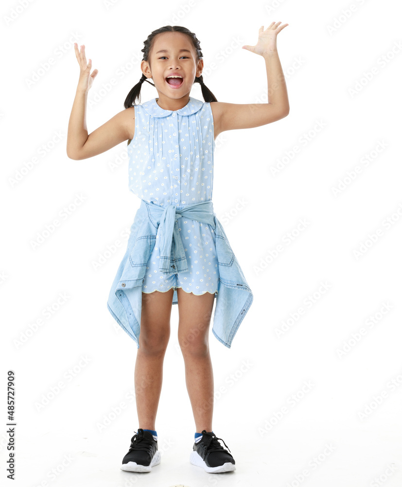 Portrait full body studio cutout shot of Asian young happy cheerful pigtail braid hairstyle elementary school girl in blue sleeveless dress standing posing smiling look at camera on white background Portrait full body studio cutout shot of Asian young happy cheerful pigtail braid hairstyle elementary school girl in blue sleeveless dress standing posing smiling look at camera on white background