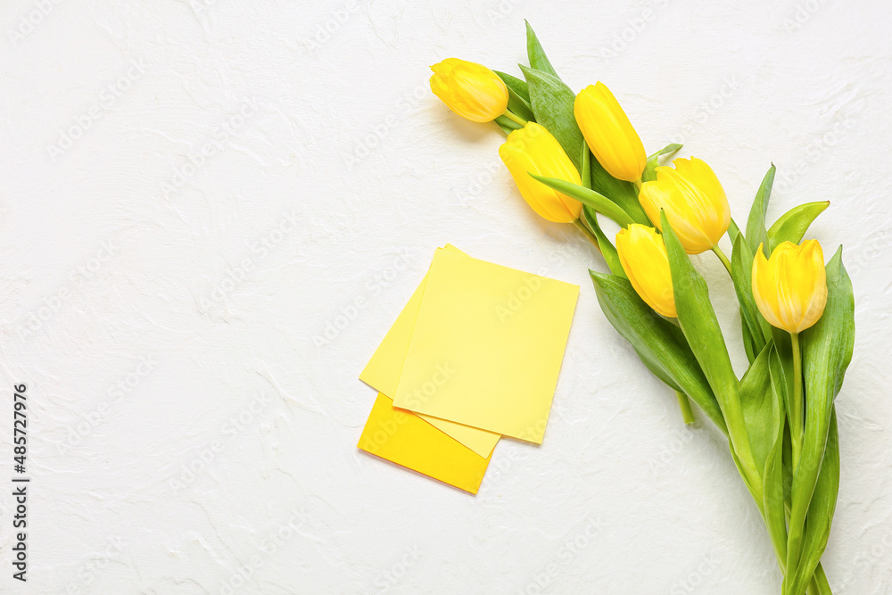 Blank greeting card for International Women's Day and tulips on light background Blank greeting card for International Women's Day and tulips on light background