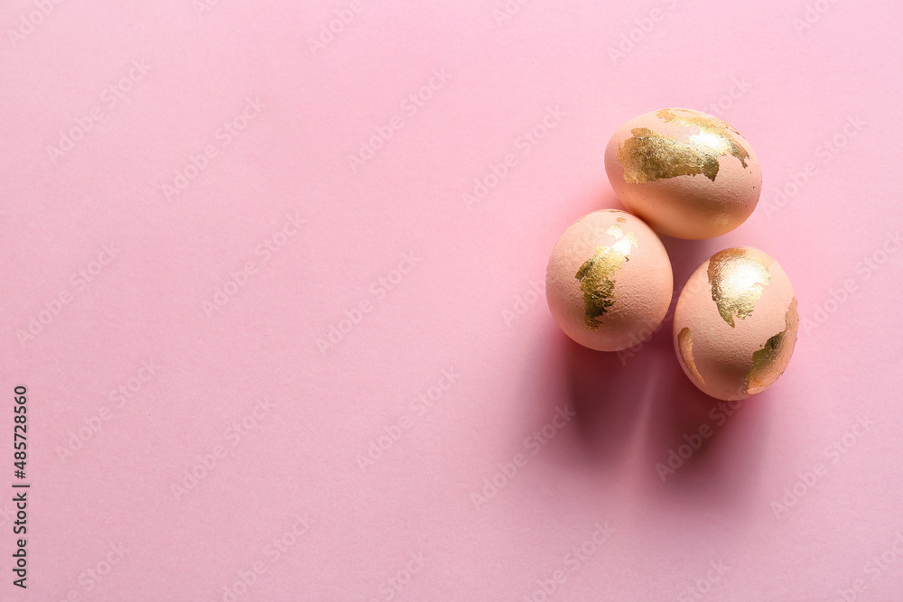 Three beautiful Easter eggs on pink background