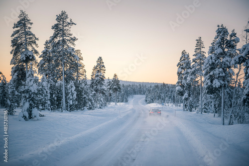 Car driving on icy snow covered roads on a road trip while travelling in Lapland inside the Arctic Circle in Finland © Matthew