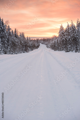 Bad driving conditions on dangerous icy roads in slippery, ice and snow covered cold weather winter scenery in Lapland, Finland, Europe