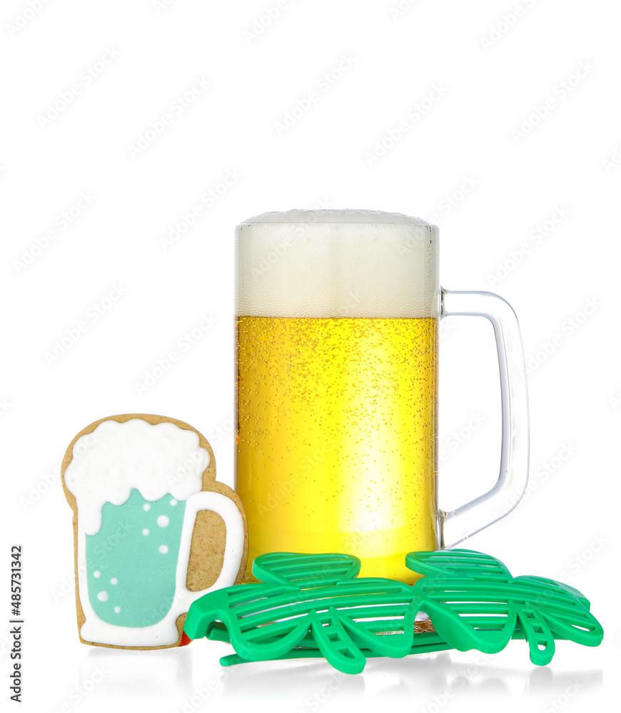 Glass of beer and gingerbread cookie for St. Patrick's Day celebration on white background Glass of beer and gingerbread cookie for St. Patrick's Day celebration on white background