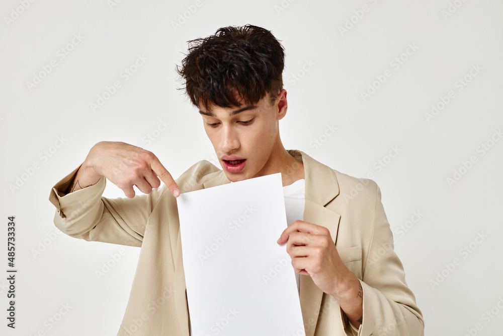 portrait of a young man posing with a notepad in a suit isolated background unaltered