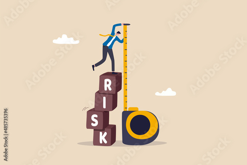 Risk assessment, analyze potential danger level, measure money loss acceptable for investing, control or limit loss concept, businessman investor stand on stack of risk boxes measure his assessment.