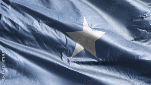 Somalia textile flag slow waving on the wind loop. Somali banner smoothly swaying on the breeze. Fabric textile tissue. Full filling background. 20 seconds loop. photo